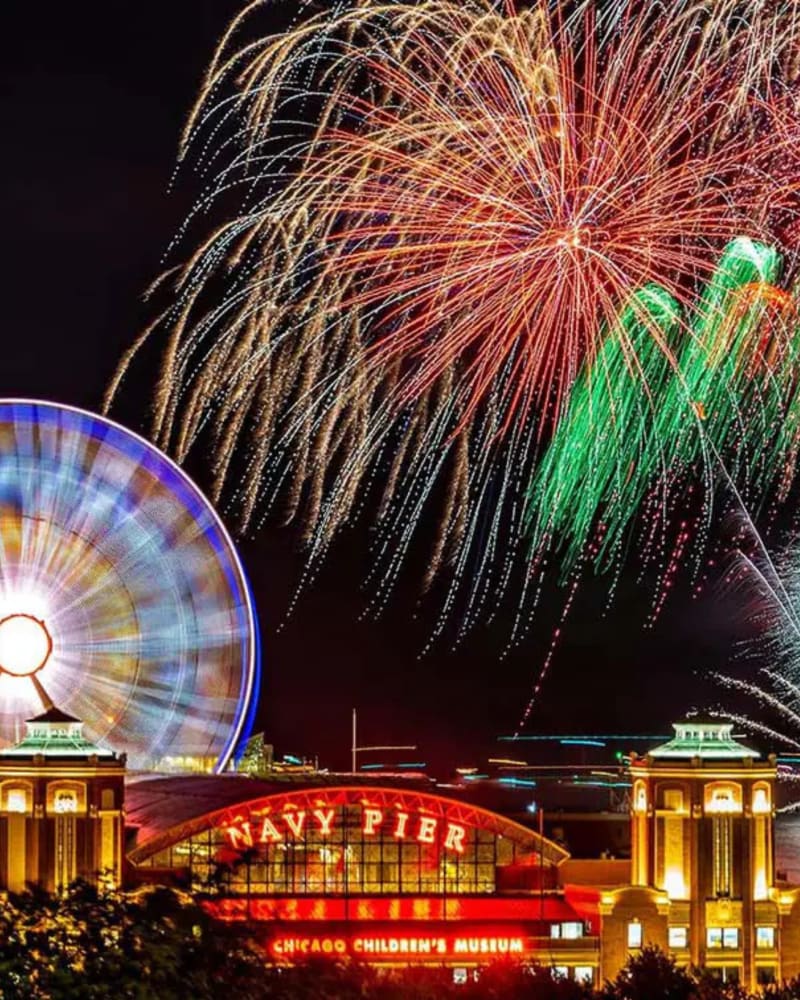 Navy Pier fireworks bursting over Lake Michigan at night