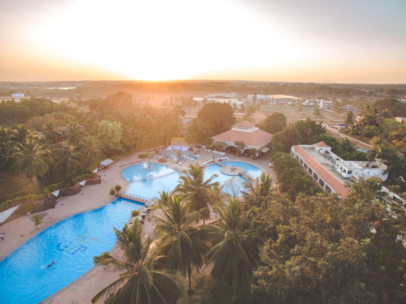 Golden Palms Hotel and Spa Bangalore outdoor wedding ceremony on lush green lawns — Panigrahana