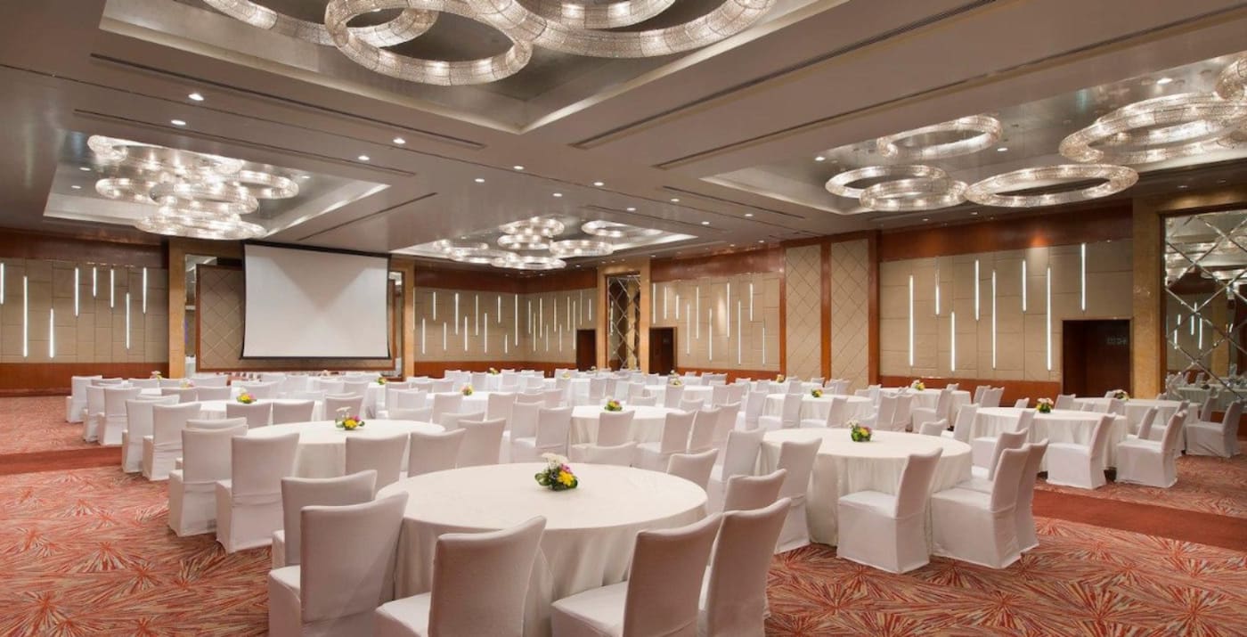 Sheraton Grand Bangalore Brigade Gateway outdoor wedding ceremony on scenic grounds — Panigrahana