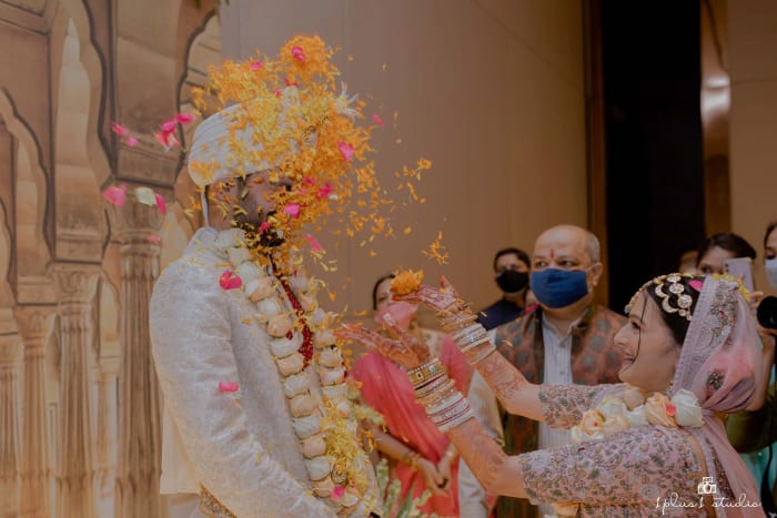 Conrad Bengaluru wedding ceremony mandap decorated with white flowers on outdoor terrace — Panigrahana