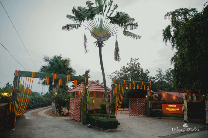 Panchavati Pavilion South Bangalore wedding lawn with floral arch and fairy lights for Indian wedding — Panigrahana