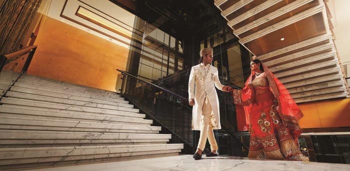 Shangri-La Hotel Bengaluru Indian wedding celebration with guests in grand reception hall — Panigrahana