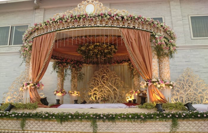 Eagleton Golf Resort Bangalore wedding reception setup on lush resort lawn surrounded by greenery — Panigrahana