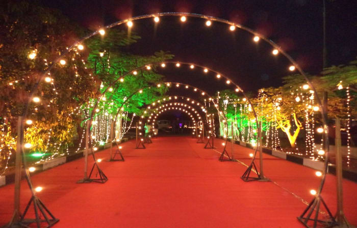 Eagleton Resort Bidadi Bangalore destination wedding decor with fairy lights and floral stage — Panigrahana