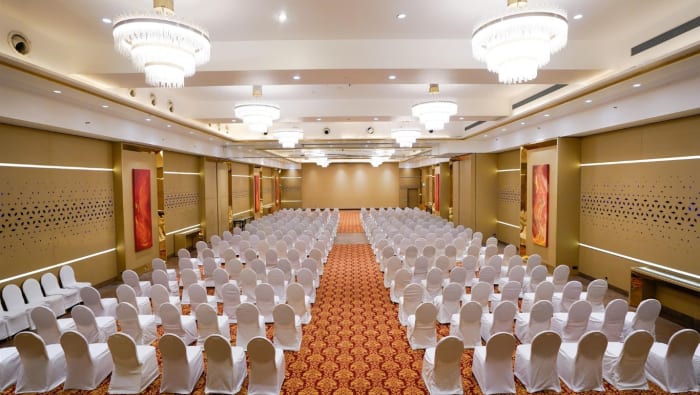 The Corinthians Resort Bangalore luxury wedding decor on banquet lawn with stage and floral arch — Panigrahana