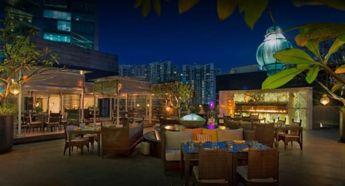 Sheraton Grand Bangalore Brigade Gateway garden wedding ceremony with marigold and rose arch — Panigrahana