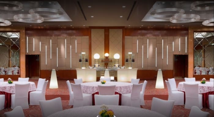 Sheraton Grand Bangalore Brigade Gateway sangeet stage with lights and drapes — Panigrahana