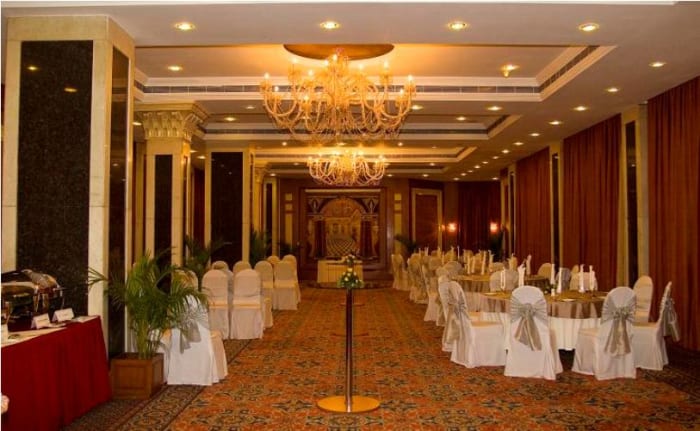 Le Méridien Bangalore elegant wedding reception with floral stage decor — Panigrahana