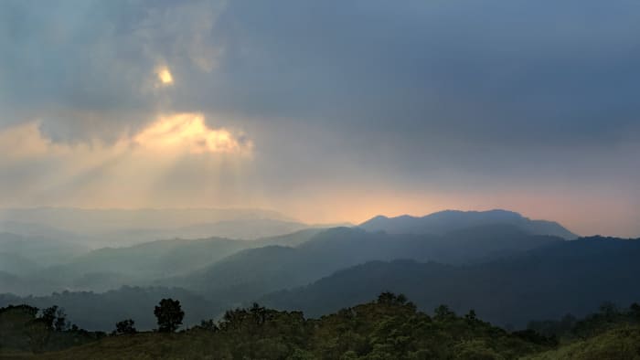 Evolve Back Coorg — Outdoor wedding mandap with Coorg hills backdrop — Panigrahana