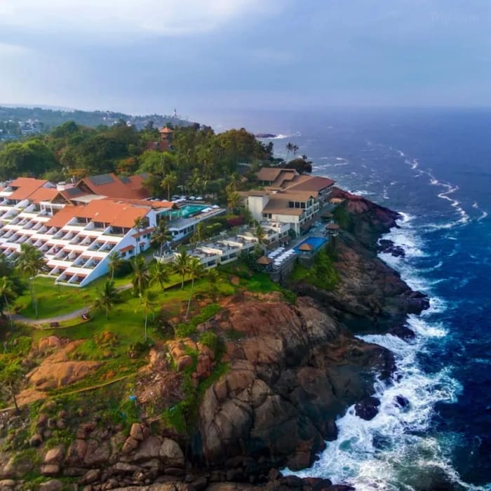The Leela Kovalam resort pool terrace with sea views set for wedding reception — Panigrahana