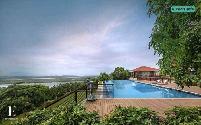 DoubleTree Hilton Panaji Goa outdoor wedding ceremony lawn with sea view floral arch — Panigrahana