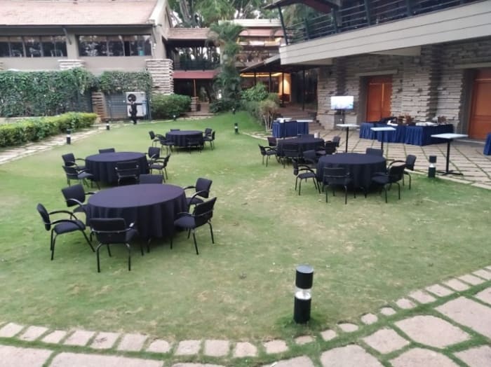 Angsana Oasis Resort North Bangalore wedding lawn with banyan trees and lush greenery — Panigrahana