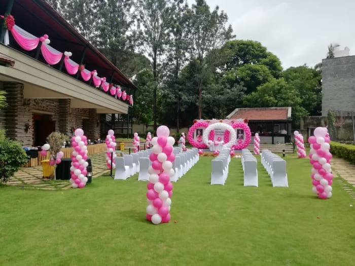 Angsana Oasis Bangalore wedding couple ceremony on lush resort garden with pool view — Panigrahana