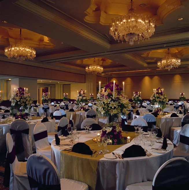 Leela Palace Bengaluru wedding reception hall with chandelier and floral stage decor — Panigrahana