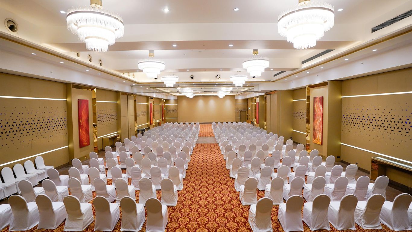 The Corinthians Resort Bangalore luxury wedding decor on banquet lawn with stage and floral arch — Panigrahana