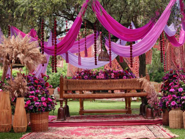 Pink bohemian mehendi setup with drapes — mehendi decor Panigrahana Bangalore