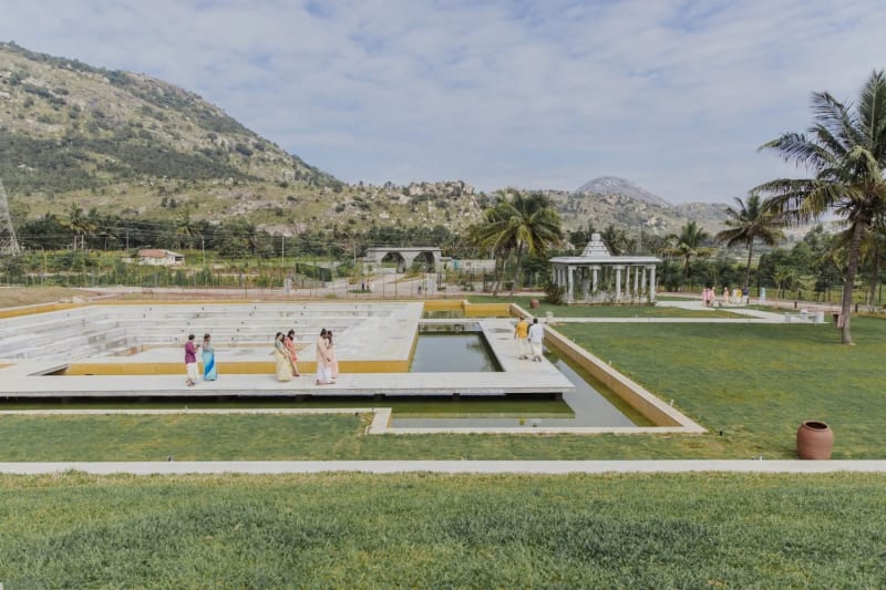 Amita Rasa Nandi Hills Bangalore outdoor wedding ceremony on lush hillside lawn with floral mandap