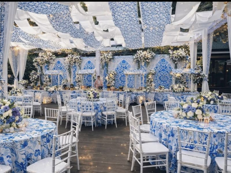 Blue and white chinoiserie wedding reception with patterned linens and parasols — outdoor wedding by Panigrahana Weddings