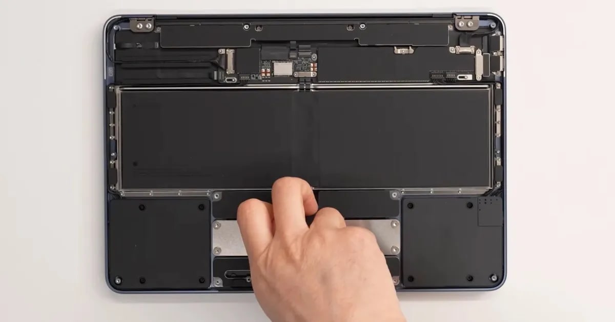 MacBook Neo interior showing screwed battery modular design iFixit repairability | ALT TEXT: MacBook Neo repairability iFixit most repairable Apple laptop long-term
