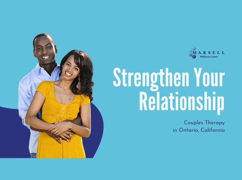 A happy couple embracing and smiling together.