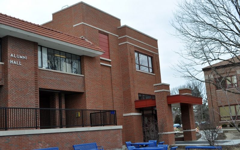 The outside brick facade of the alumni hall during winter.