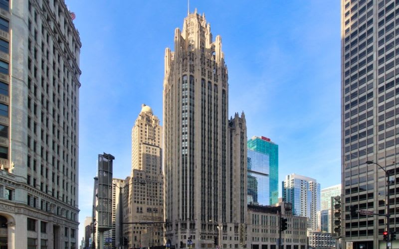 The exterior of the Tribune Tower during daytime. 