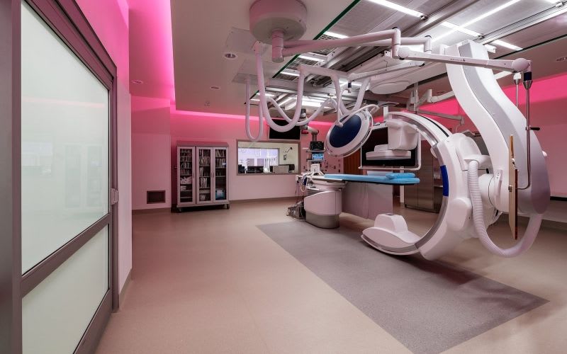 EP lab with illuminated pink lights around the medical equipment.