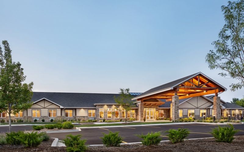 The outdoor view of Silverado Assisted Living illuminated by lights.