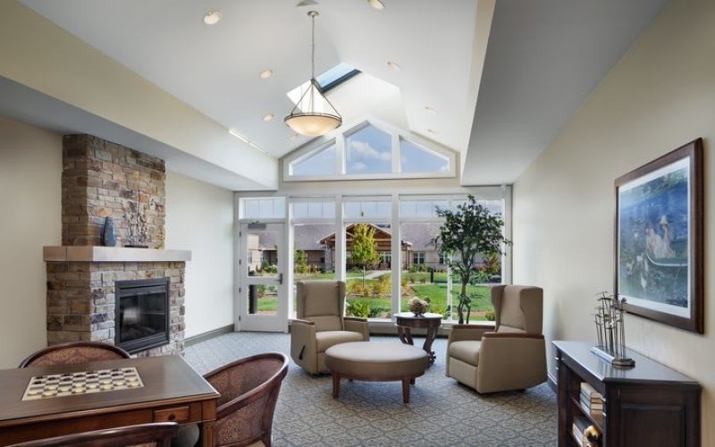 A room at Silverado with a fireplace, couches, a chess board and a skylight.