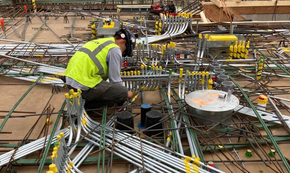 Connelly Electric construction worker assembling electrical conduits