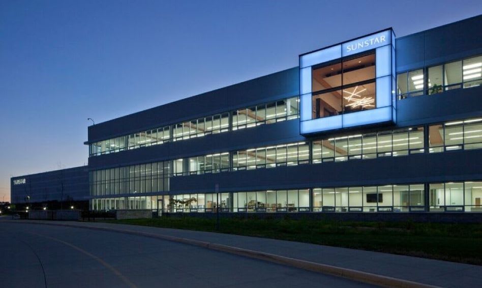 Outside view of the Sunstar building illuminated at night.