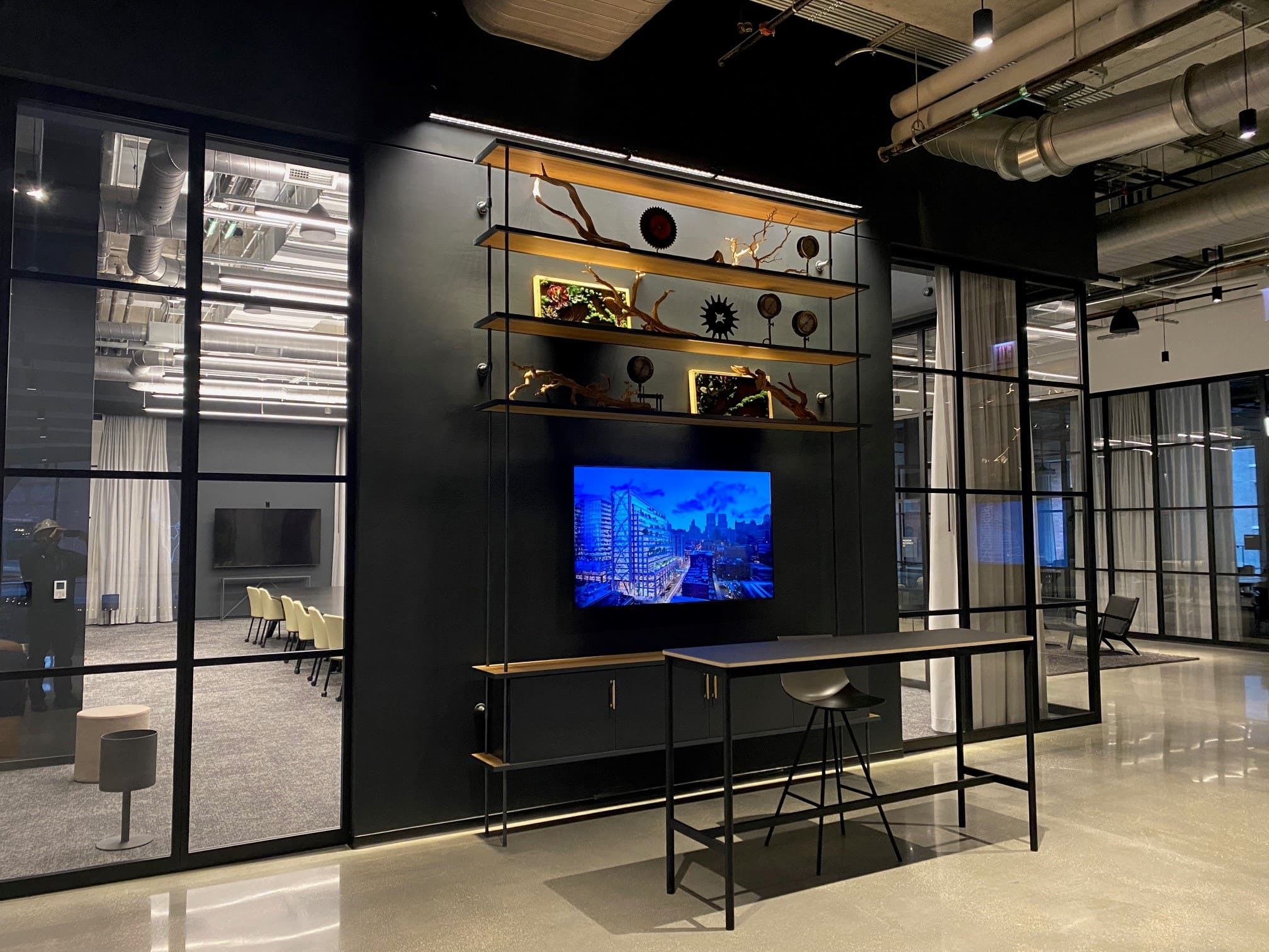 Tall metal bookshelf with decorative elements and paintings.