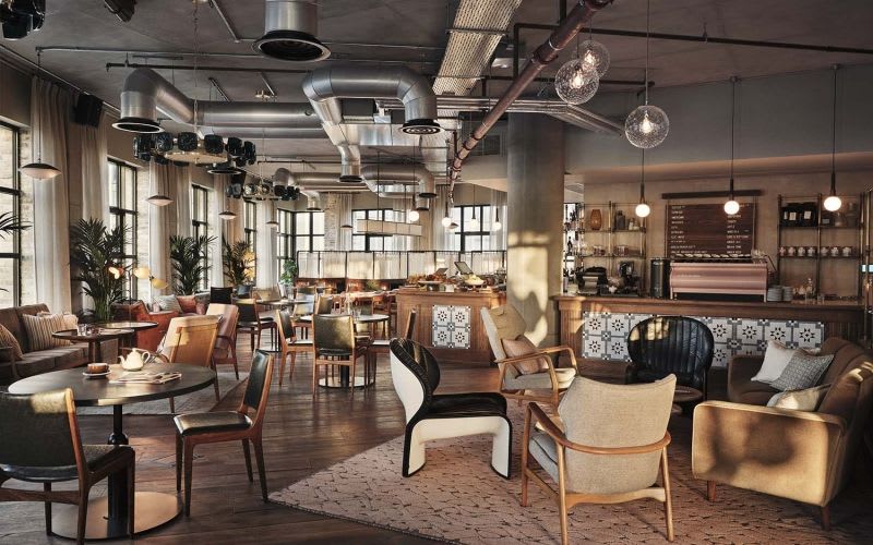 Co-working space with natural light and a mix of chairs and couches.