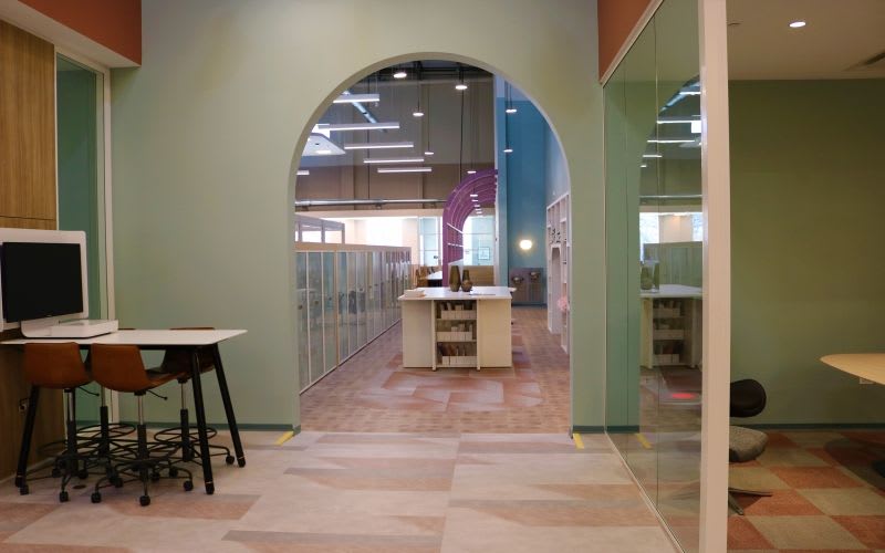 Hallway leading to co-working spaces and lockers.