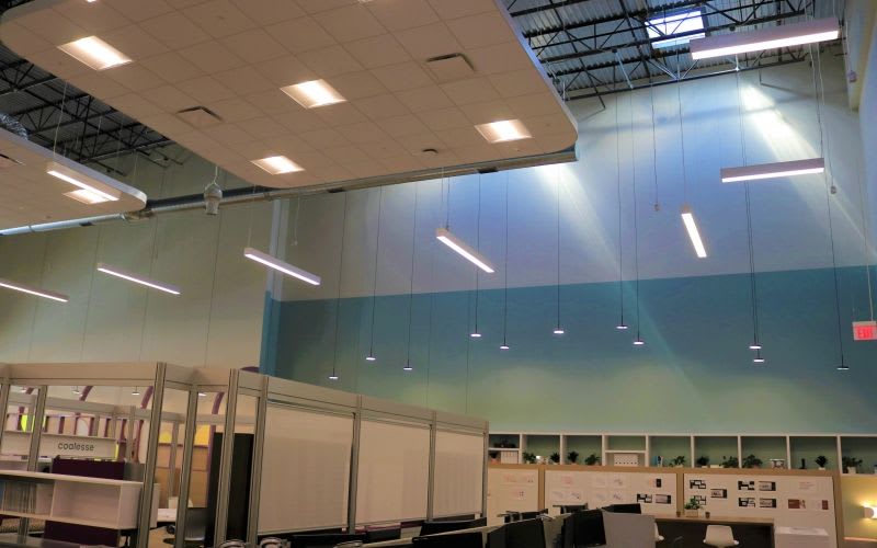 View of the multiple lights and pendant light fixtures in one of the co-working spaces.