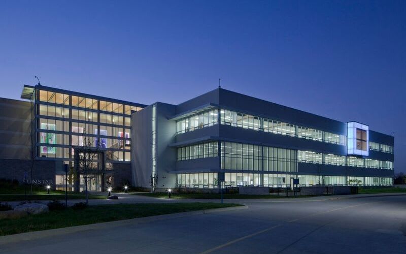 The illuminated exterior facade of Sunstar at nighttime.