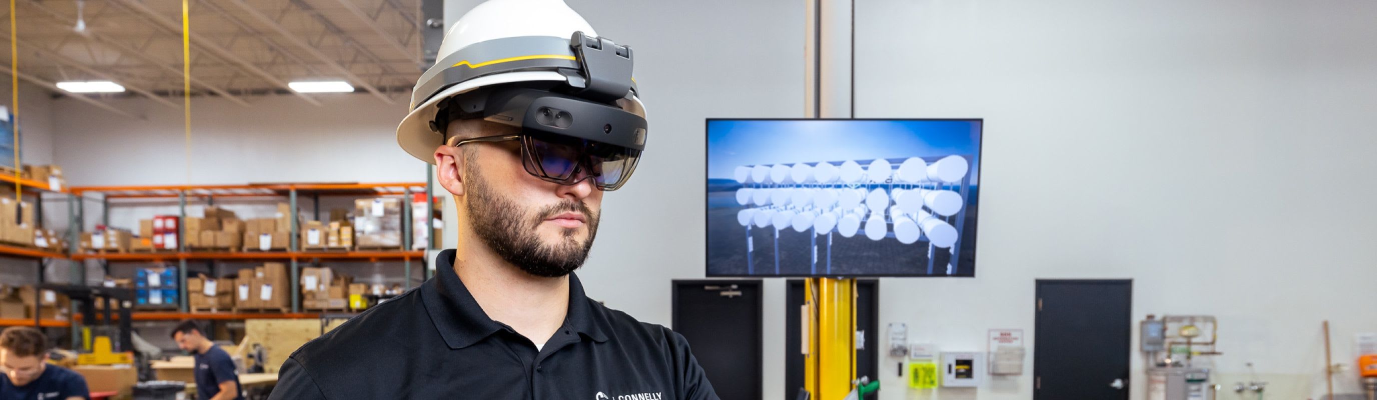 A Connelly Electric VDC Engineer managing a Building Information Model (BIM) for an electrical construction project through a VR headset.