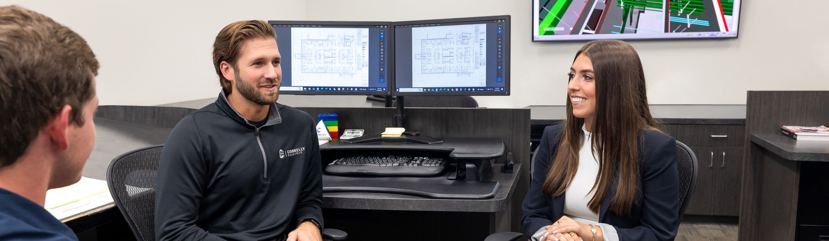 Electrical Engineers collaborating in the office at the Connelly Electric HQ.