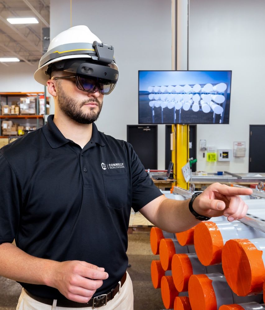 A Connelly Electric VDC Engineer managing a Building Information Model (BIM) for an electrical construction project through a VR headset.