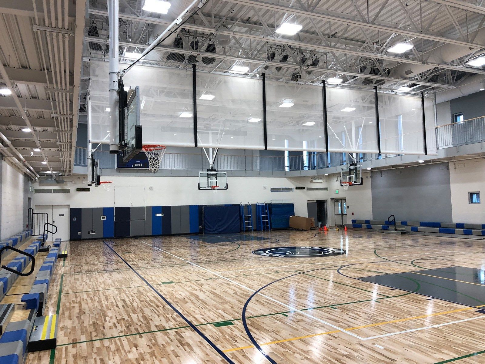 East Prairie's gym, showcasing a wooden basketball court with bright lighting.