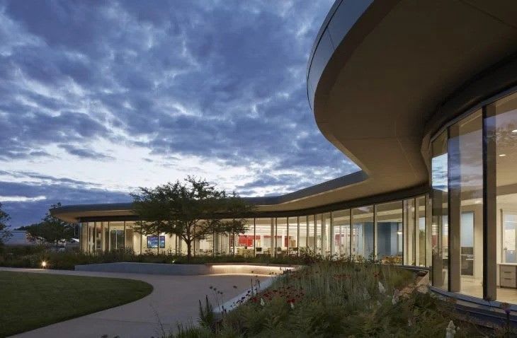 The outside of the center, illuminated from the inside at night.