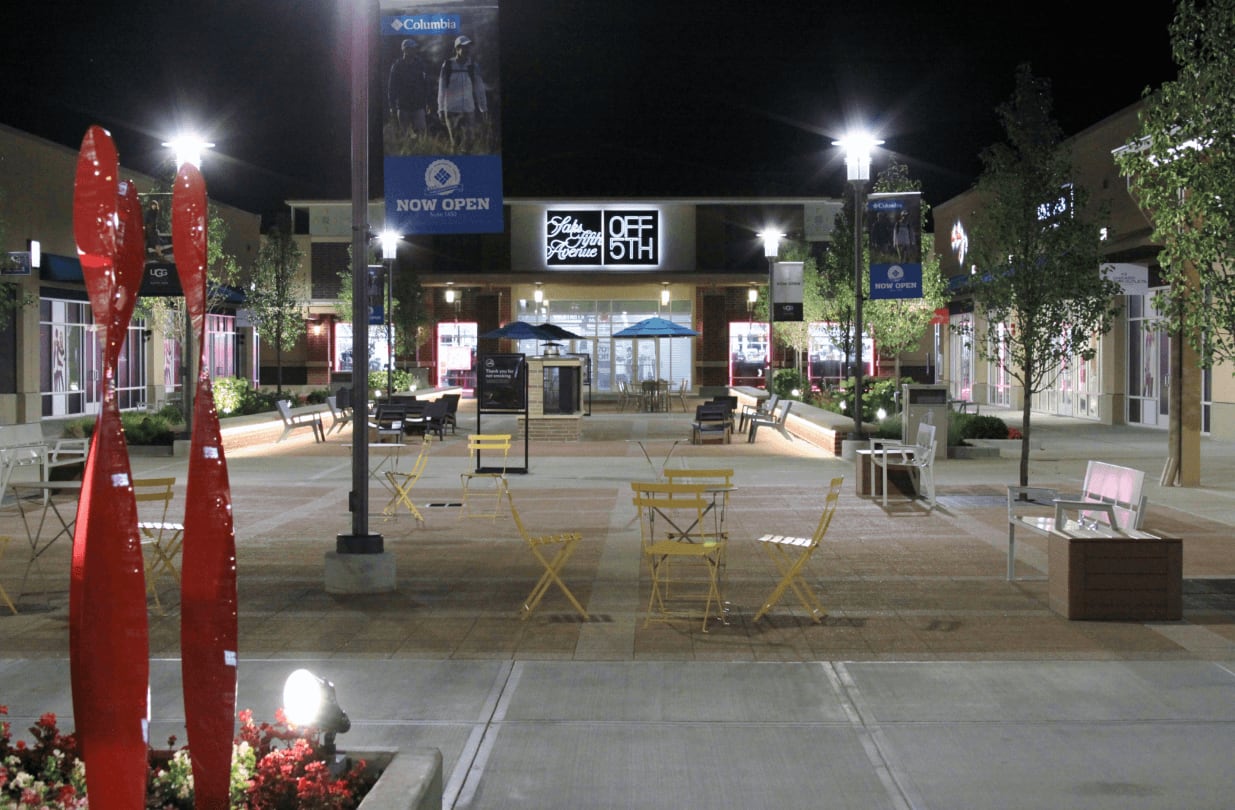 The outside area in front of Saks Fifth Avenue, showing a couple seating options and decorative elements.