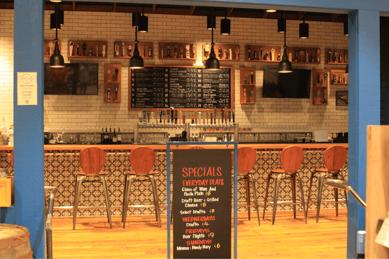A small bar inside a Whole Foods with chairs and a beer tap system.