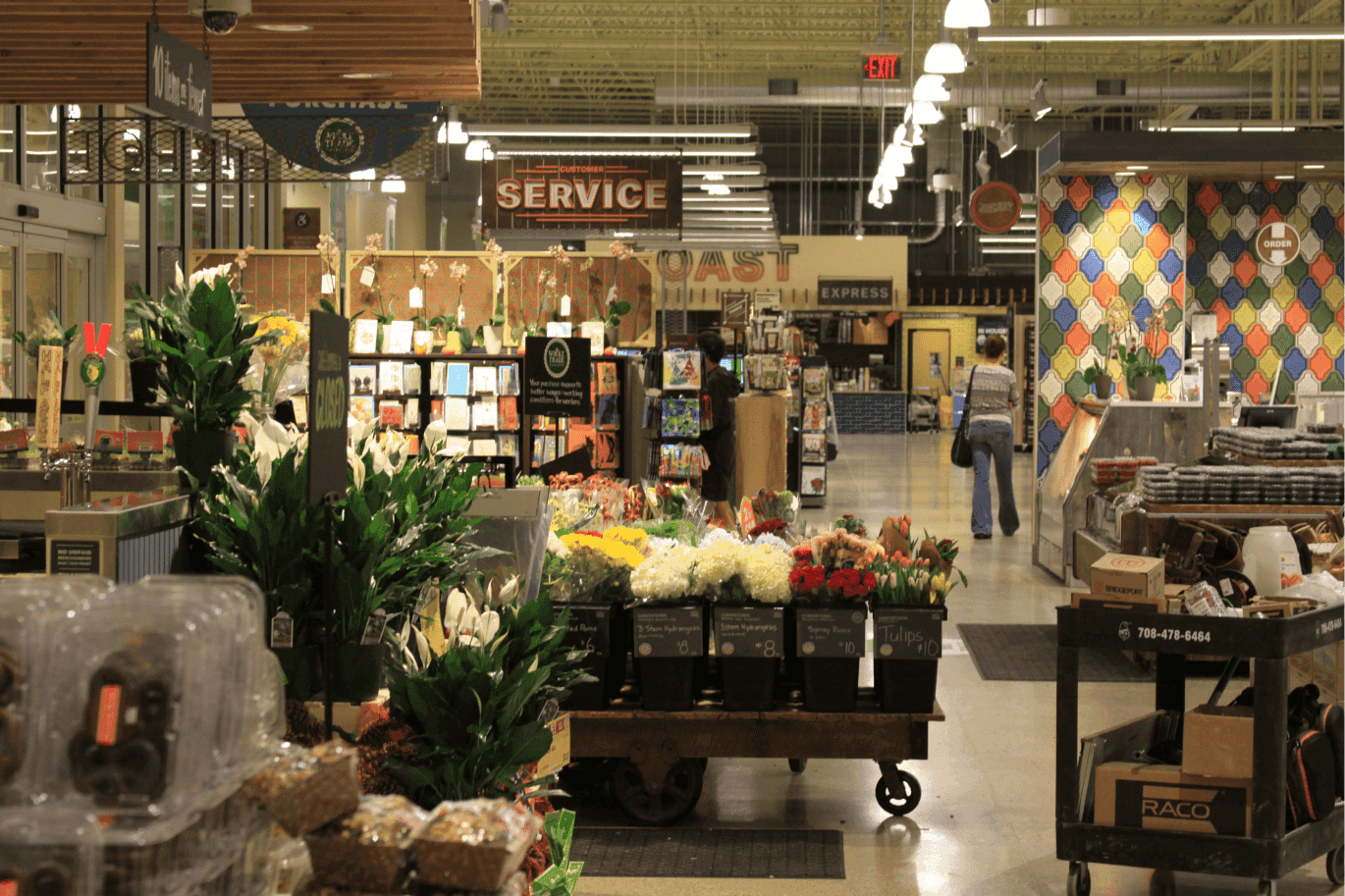 Entrance of the Whole Foods in Willowbrook showing flowers, greeting cards and small gift bags.
