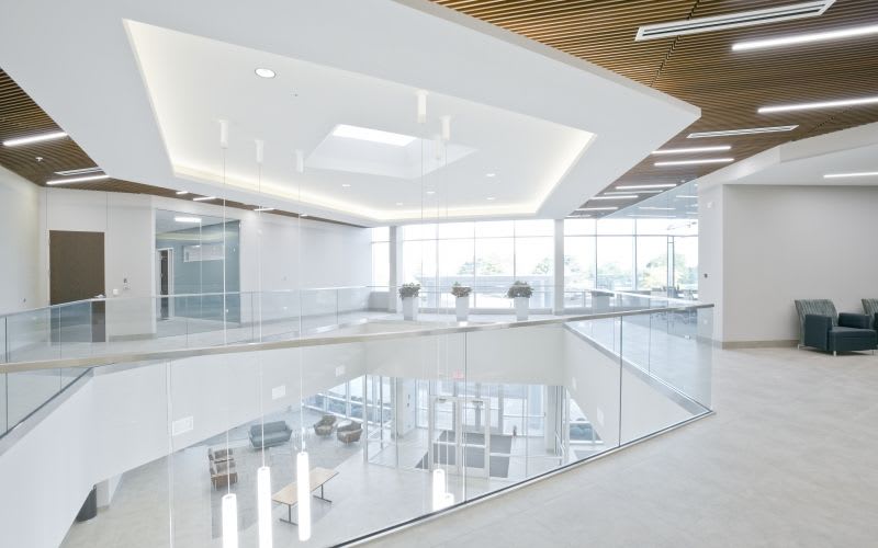 The second floor of the building, showing glass-walls, a skylight and various types of lighting.