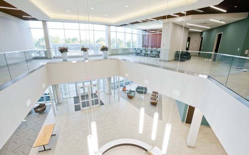 Indoor view of the entrance from the top with illuminated pendant light fixtures.