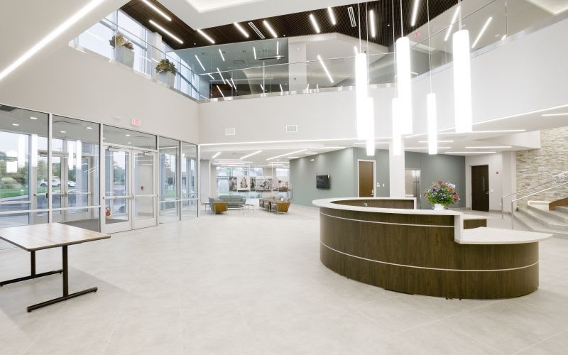 The entrance of Echo Corporate Center showing a variety of lighting options, including linear and pendant lighting.