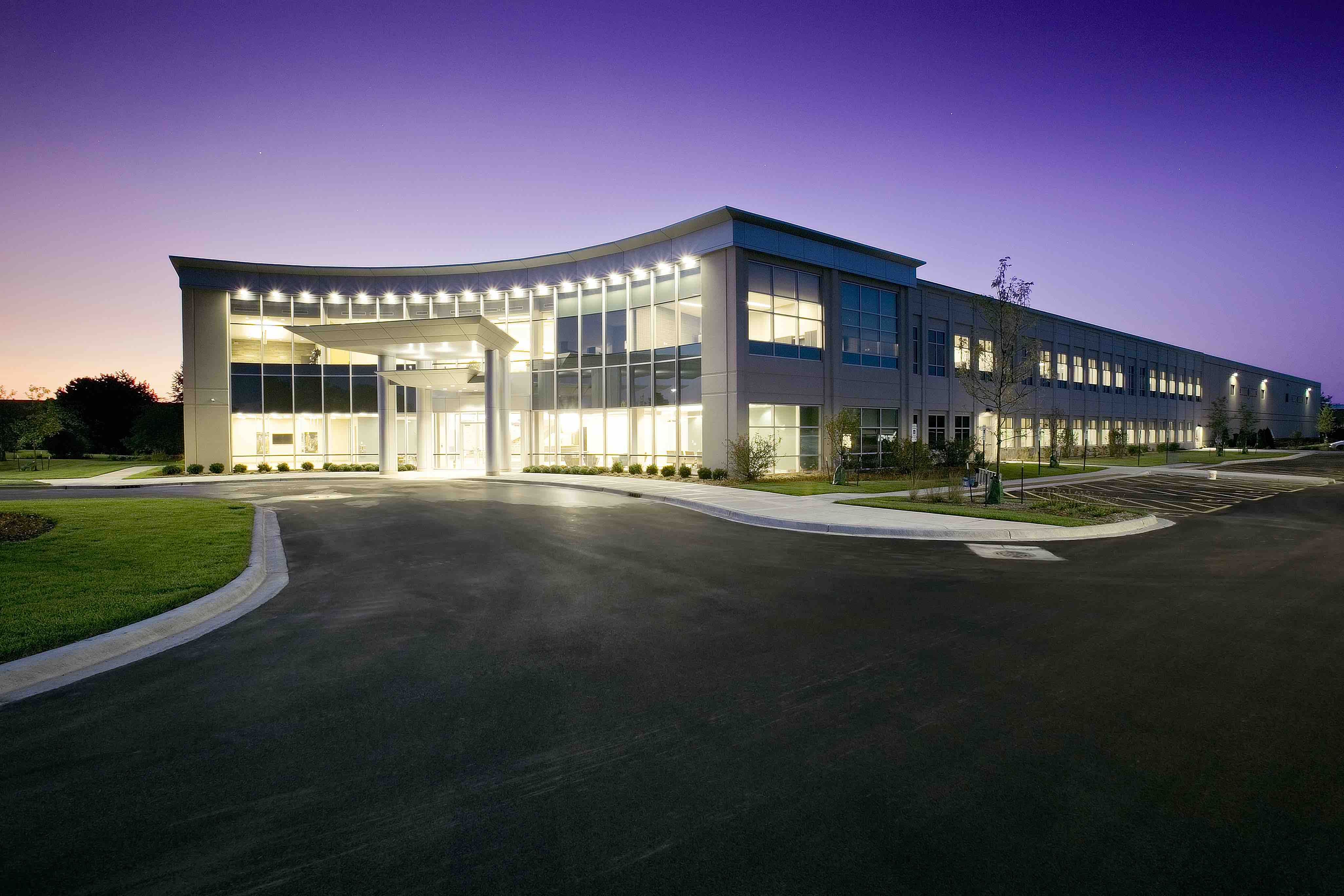 The exterior view of Echo Corporate Center illuminated at night.
