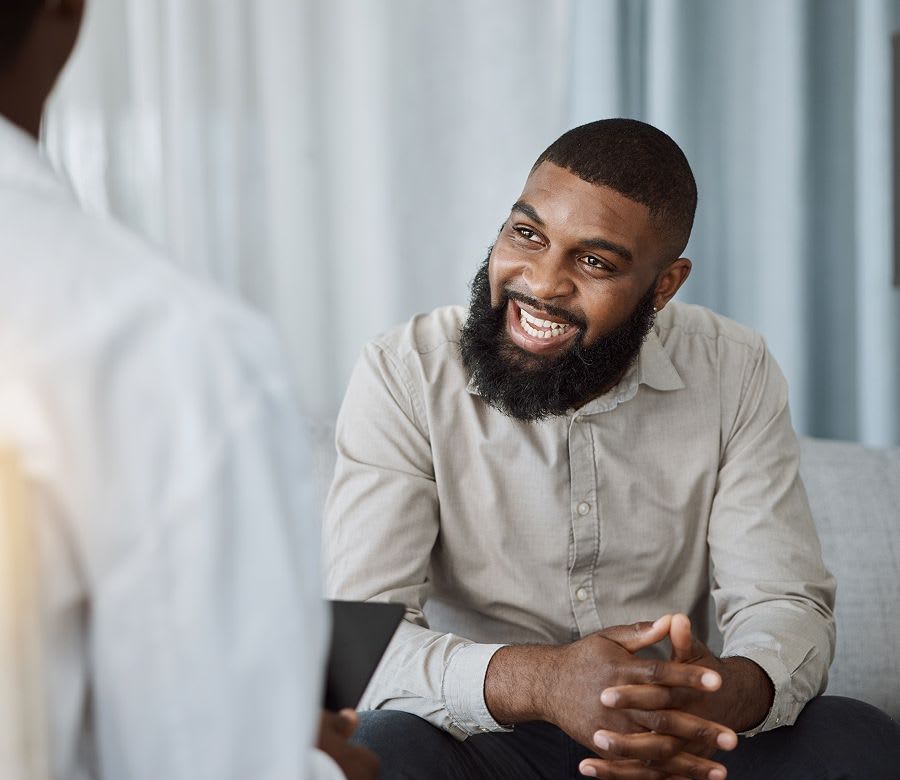 man sitting with a smile on his face in meeting