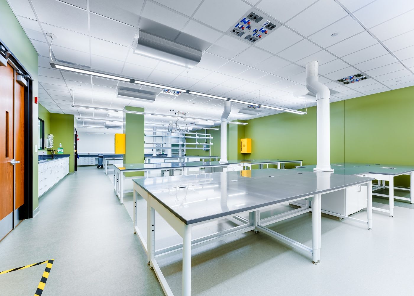 Two large lab desk areas, with many bright overhead lights.